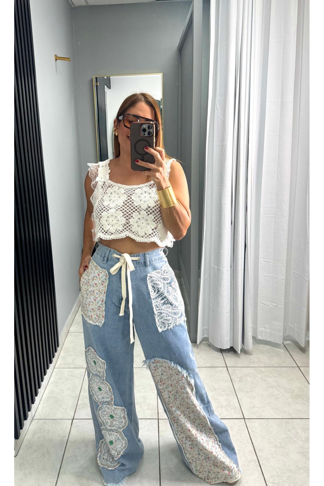 Designed in relaxed fit pants in denim with floral patch detail.